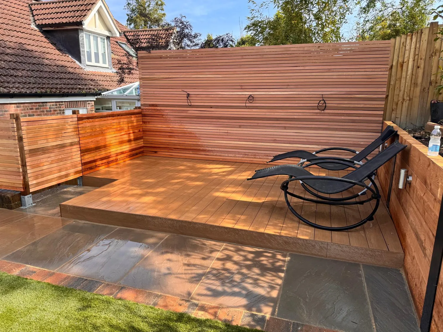 Hardwood decking wrapping into a corner with a rocking chair